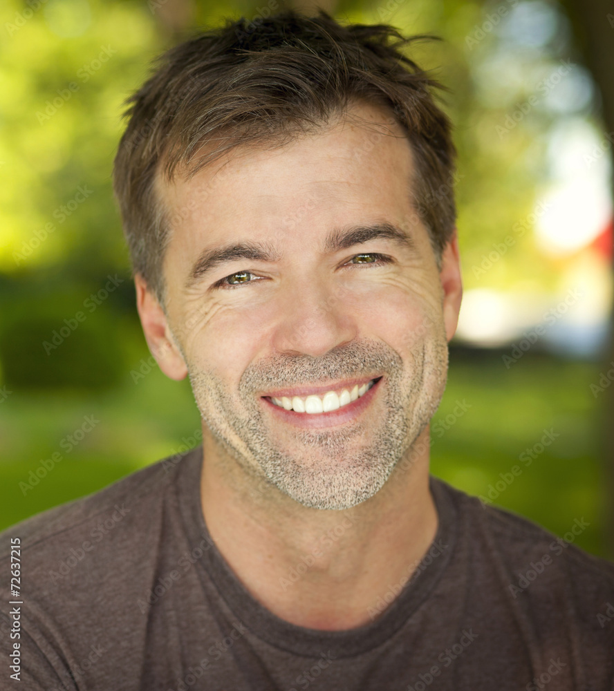 Portrait Of A Mature Confident Man Smiling At The Camera Portrait Of A Mature Confident Man Smiling At The Camera