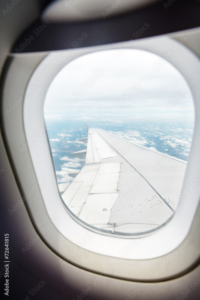Clouds and sky as seen through window of an aircraft Clouds and sky as seen through window of an aircraft