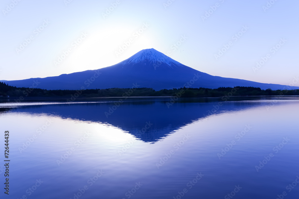 Sun shine and inverted Mount Fuji reflected in Lake Tanukiko
