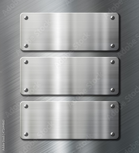 three stainless steel metal plates on brushed background