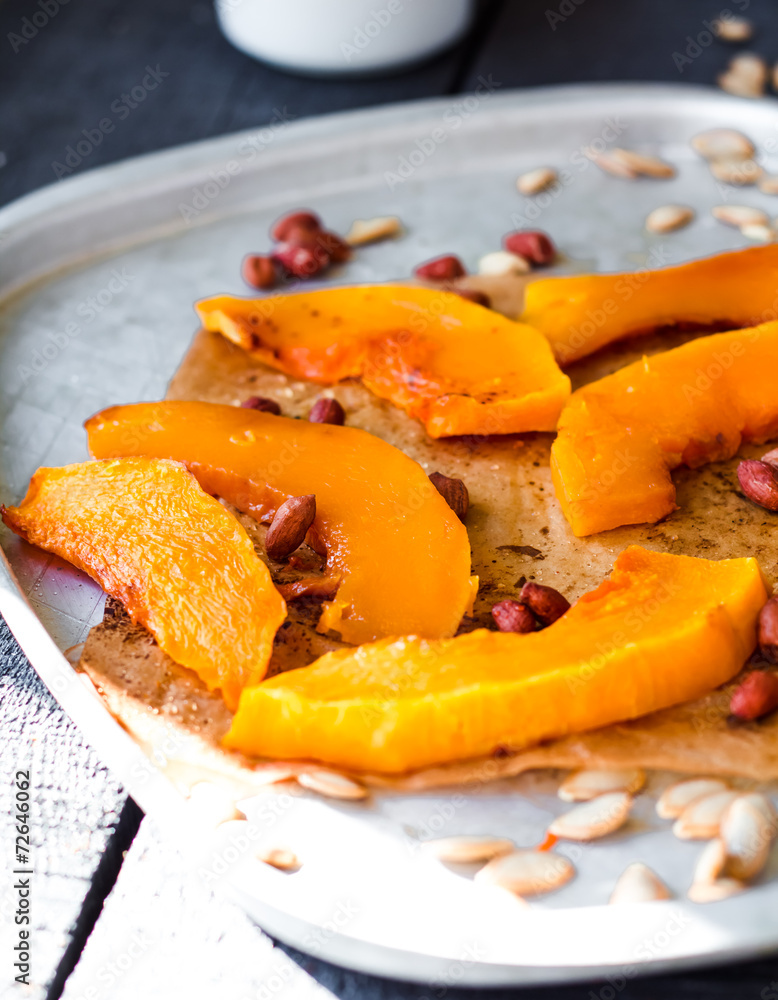 baked pumpkin slices with cinnamon and honey on parchment baked pumpkin slices with cinnamon and honey on parchment