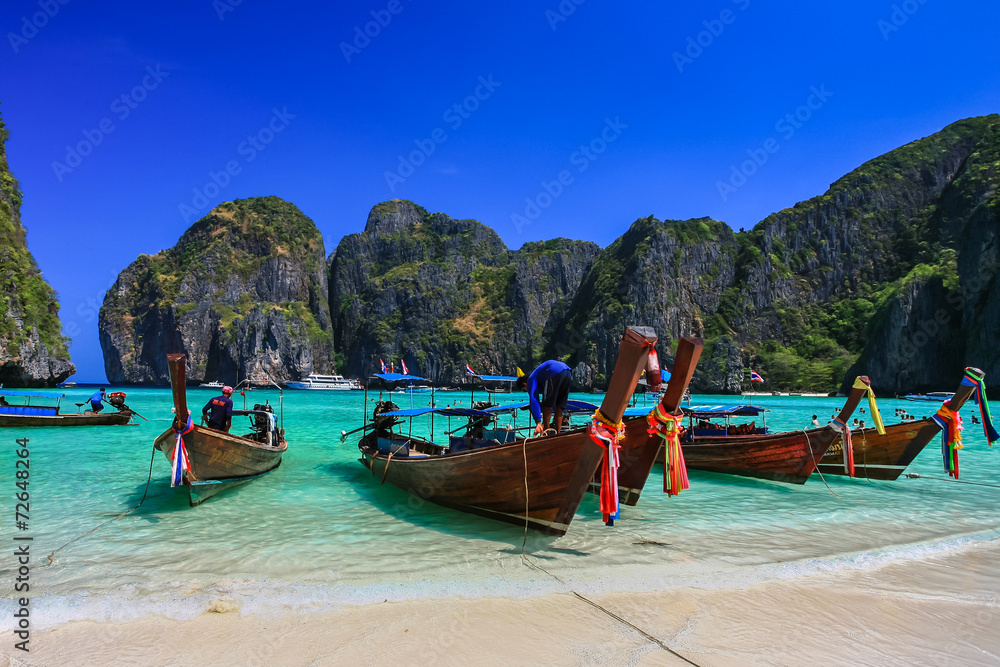 Fototapeta premium Long tail boat on white sand beach with crystal clear sea