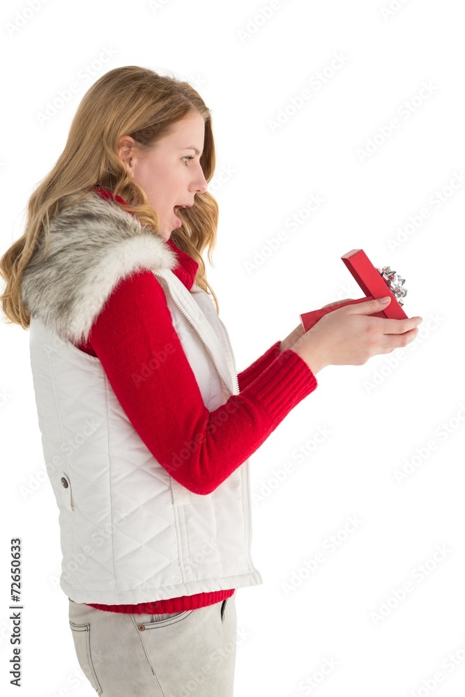 Naklejka premium Surprised blonde woman opening gift