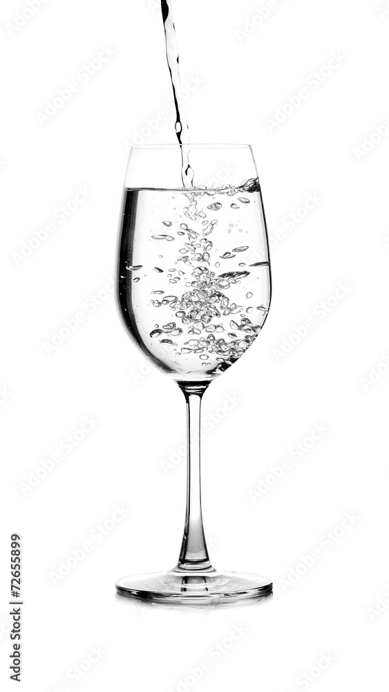 pouring water on a glass on white background pouring water on a glass on white background