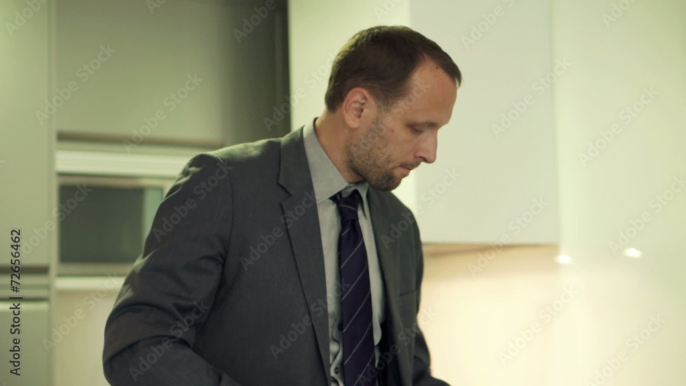 Young businessman spreading butter on slice of bread Young businessman spreading butter on slice of bread