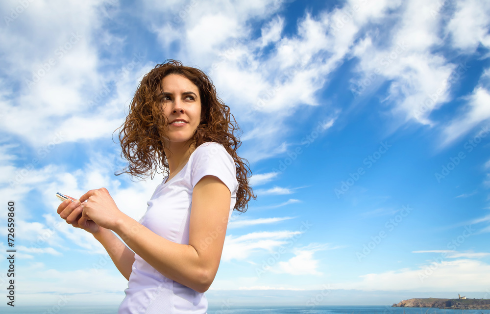 Young woman with sportswear looking her smartphone Young woman with sportswear looking her smartphone