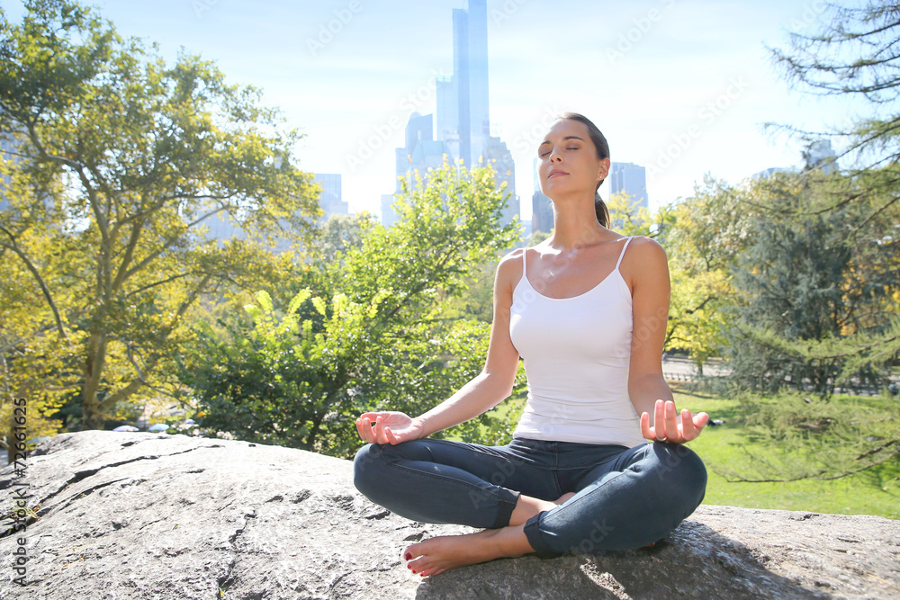 Woman doing yoga exercises in Central Park, NYC