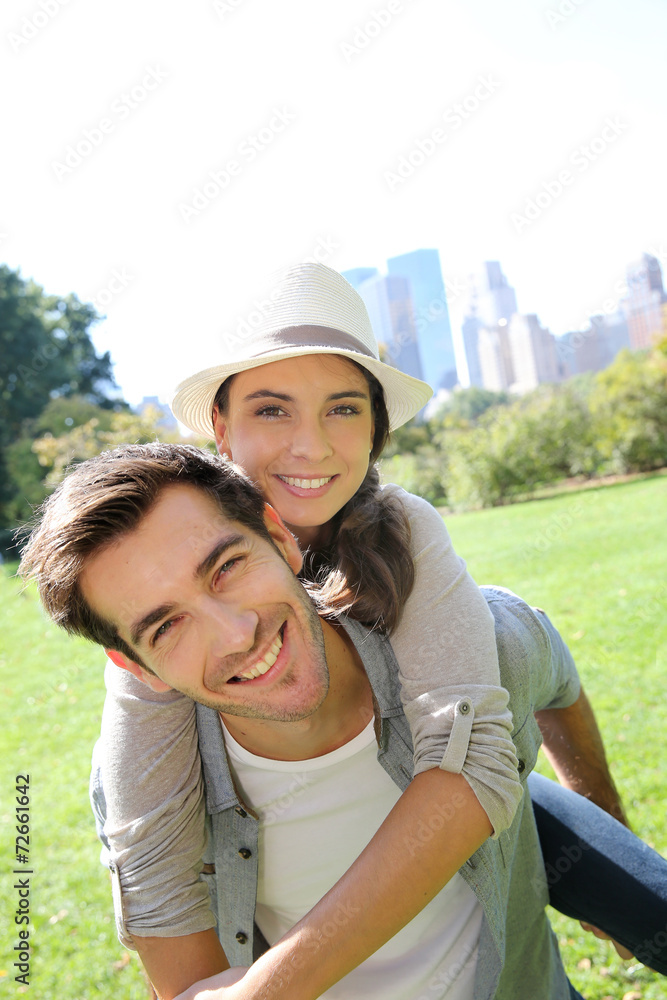 Man giving piggyback ride to girlfriend in Central Park Man giving piggyback ride to girlfriend in Central Park