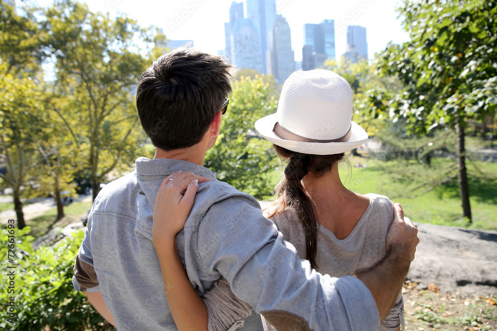 Back view of couple in Central Park enjoying skyline
