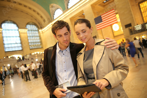 Couple in Grand Central station looking at train departure time