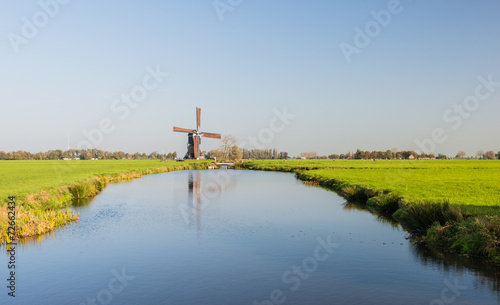 Fotografie, Obraz Dutch polder landscape with windmill