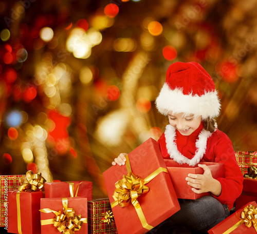 Christmas Kid Opening Present Gift Box, Happy Child in Santa Hat © inarik