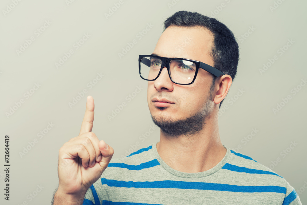 Closeup portrait of young business man pointing up having idea Closeup portrait of young business man pointing up having idea