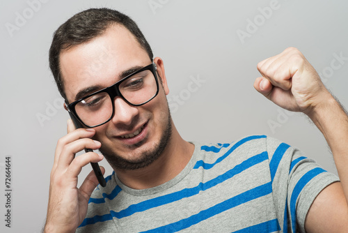 successful young man talking on the phone