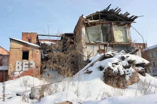 Deserted and a demolished old brick house in the winter city