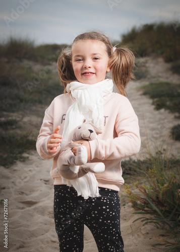 Little girl portrait on the beach photo