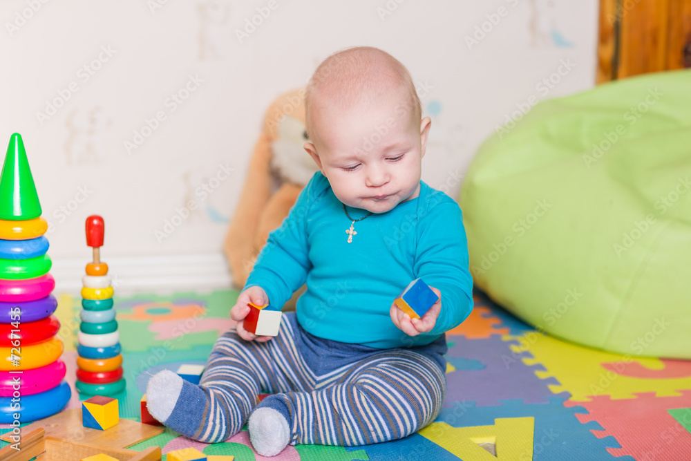 Cute little baby playing with colorful toys Cute little baby playing with colorful toys