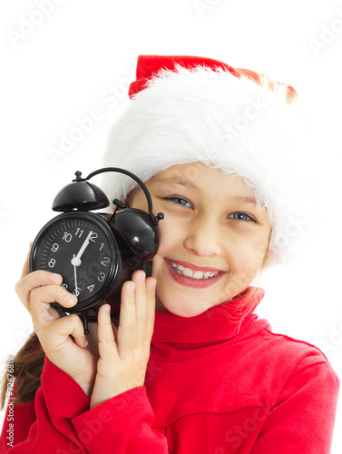 Obraz na płótnie portrait of a smiling little girl in a Santa hat is holding alar