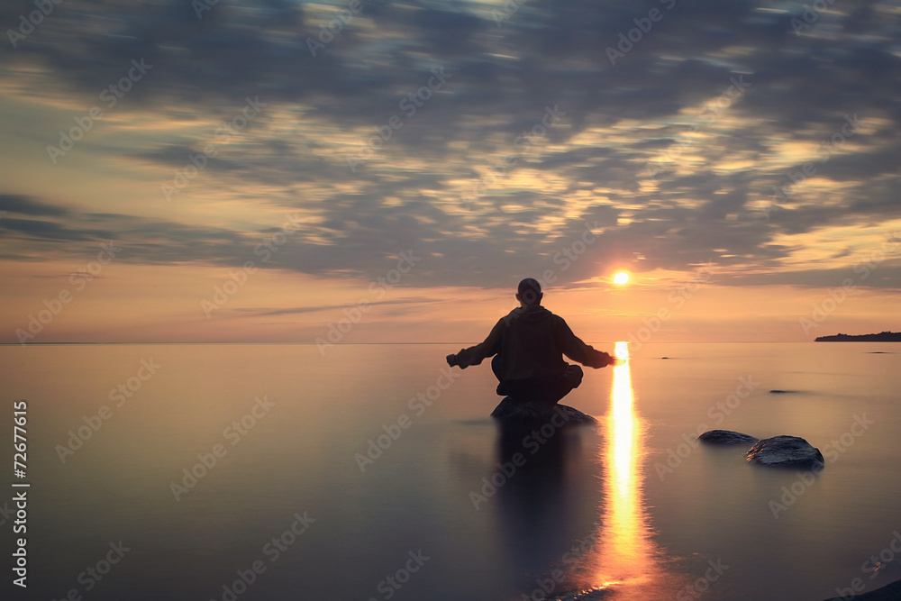man meditates on the lake
