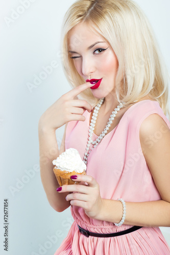 sexy elegant blonde woman with pink dress cupcake in her hands