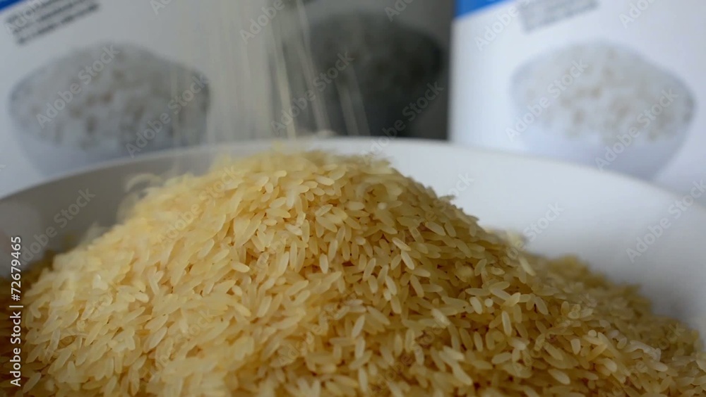 pouring natural rice into plate - boxes with white rice pouring natural rice into plate - boxes with white rice