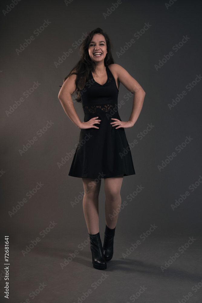 Cute brunette teenage girl wearing black dress. Studio fashion s Cute brunette teenage girl wearing black dress. Studio fashion s