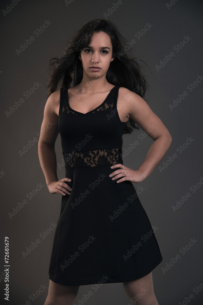 Cute brunette teenage girl wearing black dress. Studio fashion s Cute brunette teenage girl wearing black dress. Studio fashion s
