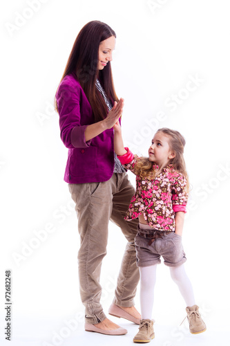 beautiful little girl her mother. Stylish clothing isolated