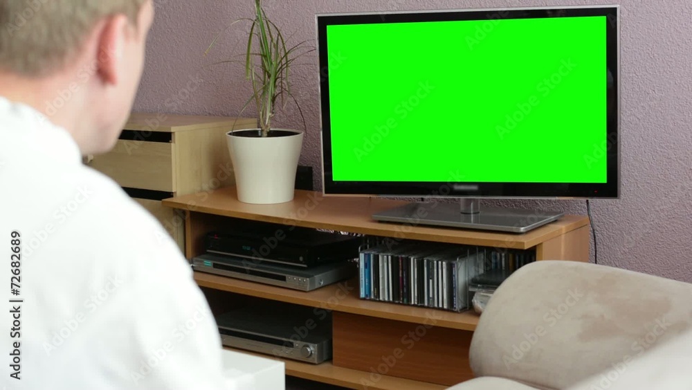 Man watches TV(television) - green screen Man watches TV(television) - green screen