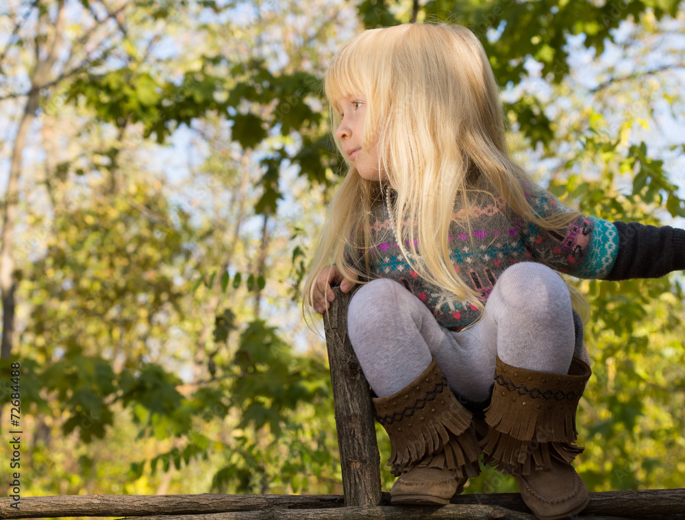 Happy little girl balancing on a fence Happy little girl balancing on a fence