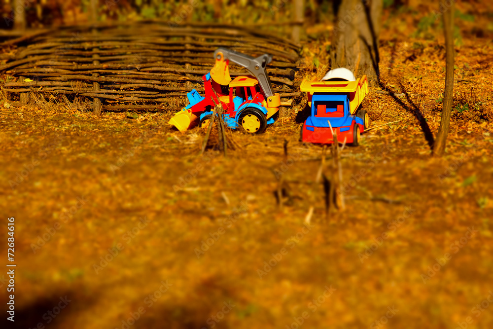 Colored Truck Toys on Brown Landscape