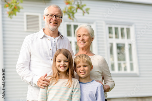 happy family in front of house outdoors © Syda Productions