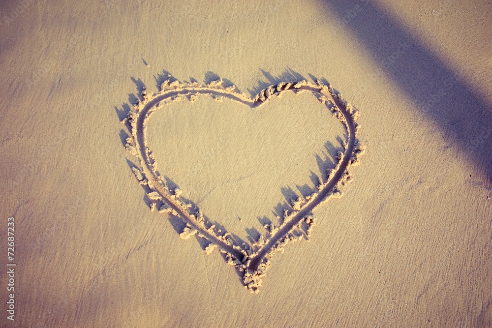 Heart drawn in the sand. Beach background and top view Heart drawn in the sand. Beach background and top view