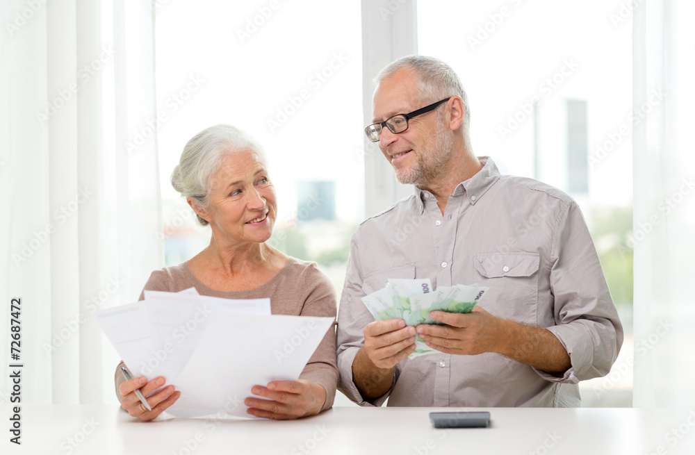 senior couple with money and calculator at home senior couple with money and calculator at home