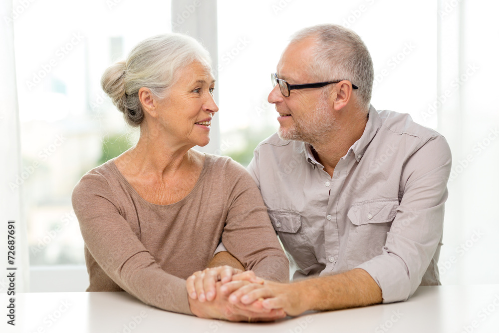 happy senior couple sitting on sofa at home happy senior couple sitting on sofa at home