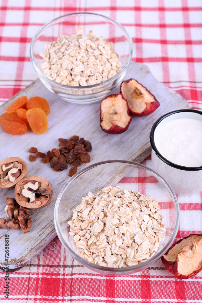 Oatmeal in bowls, mug of yogurt, marmalade, chocolate, raisins, Oatmeal in bowls, mug of yogurt, marmalade, chocolate, raisins,