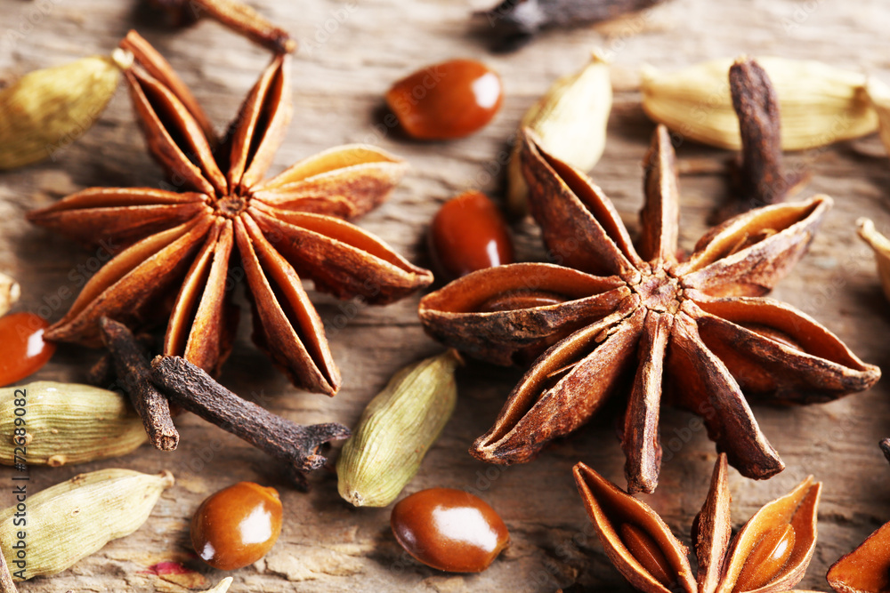 Stars anise with cardamom and carnation on wooden background Stars anise with cardamom and carnation on wooden background