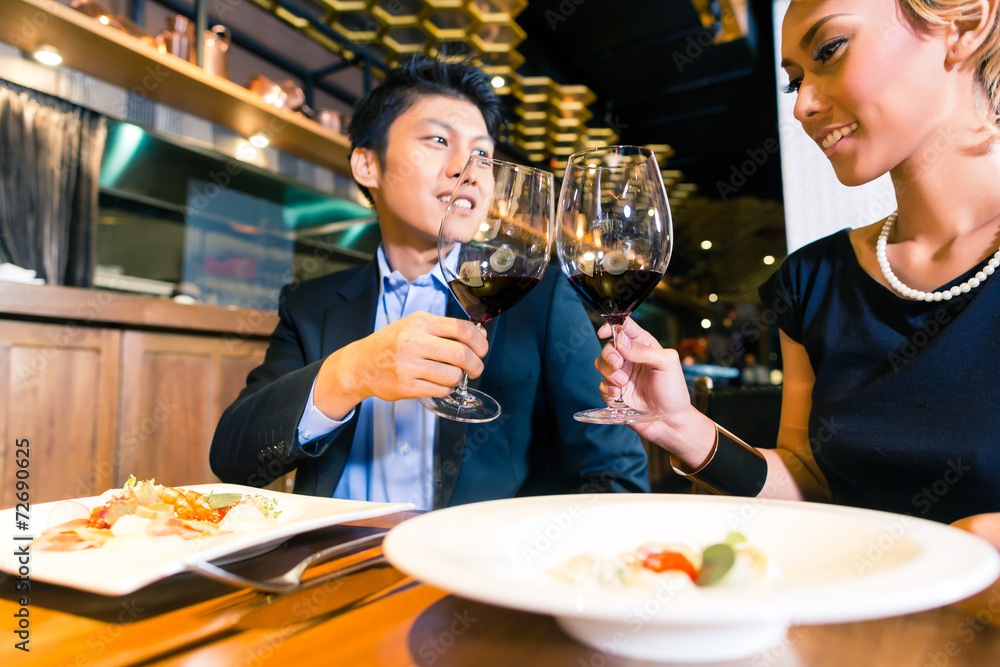 Asian couple toasting with red wine Asian couple toasting with red wine