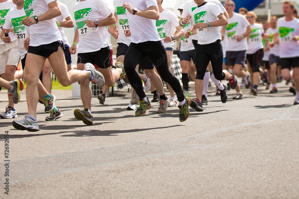 Marathon running race, people feet on autumn road Marathon running race, people feet on autumn road