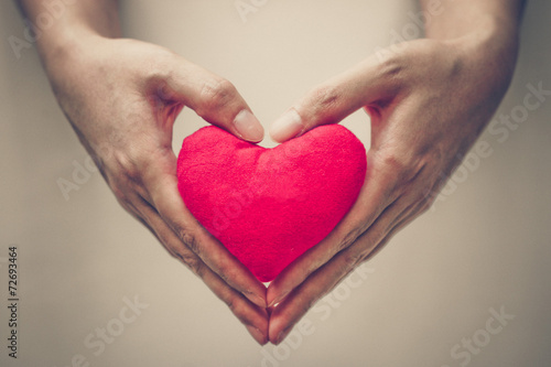 hands holding a red heart