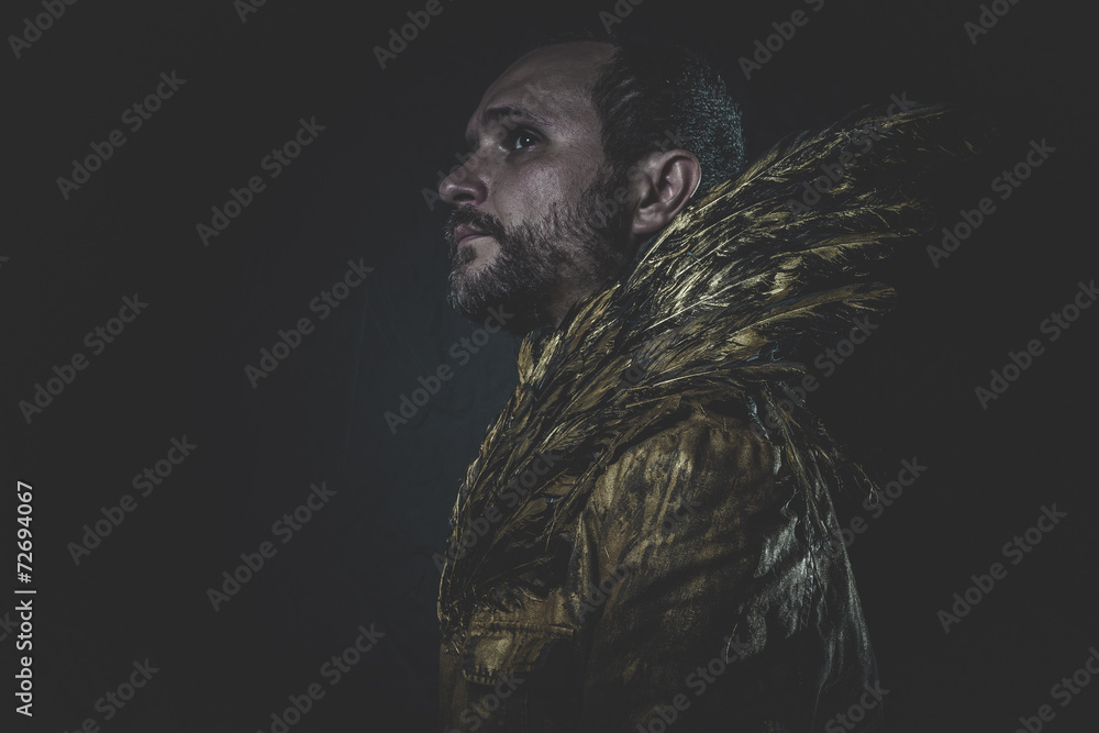 Fallen angel, man beard and suit made with golden wings Fallen angel, man beard and suit made with golden wings