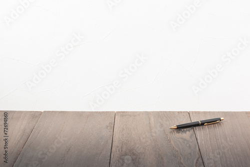 Desk. Office supply on Desk.Empty Wall of Stucco.