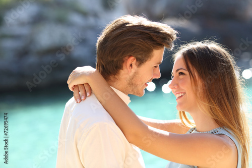 Couple in vacations looking each other ready to kiss