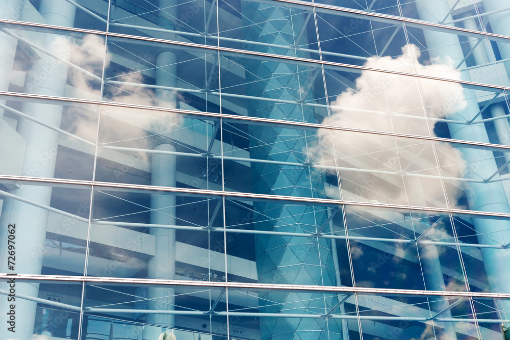 Clouds reflected in windows of modern office building