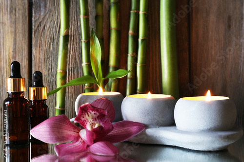 Fototapeta Naklejka Na Ścianę i Meble -  Spa set on mirror surface on wooden wall background