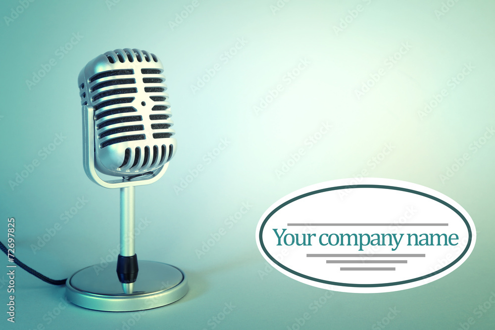 Old metal microphone on light blue background Old metal microphone on light blue background