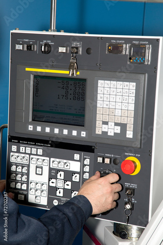 Man hand the controls of a machine CNC