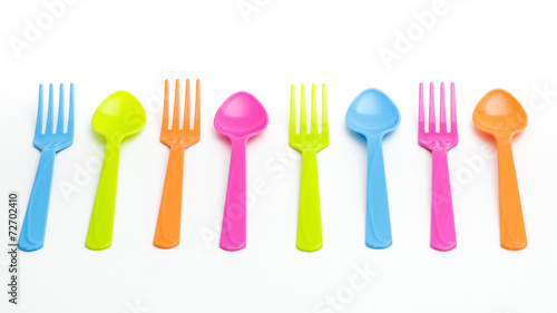 Colorful fork and spoon on white background