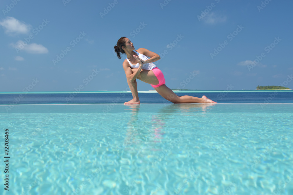 Asian chinese woman practising yoga by the sea Asian chinese woman practising yoga by the sea