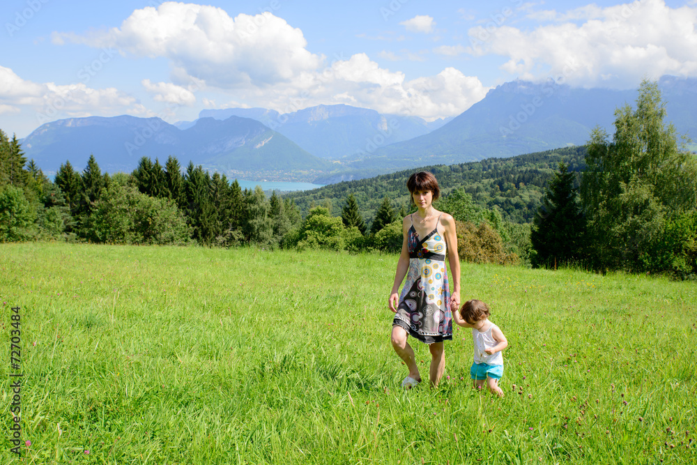 a beautiful mother and daughter walking in the mountains a beautiful mother and daughter walking in the mountains